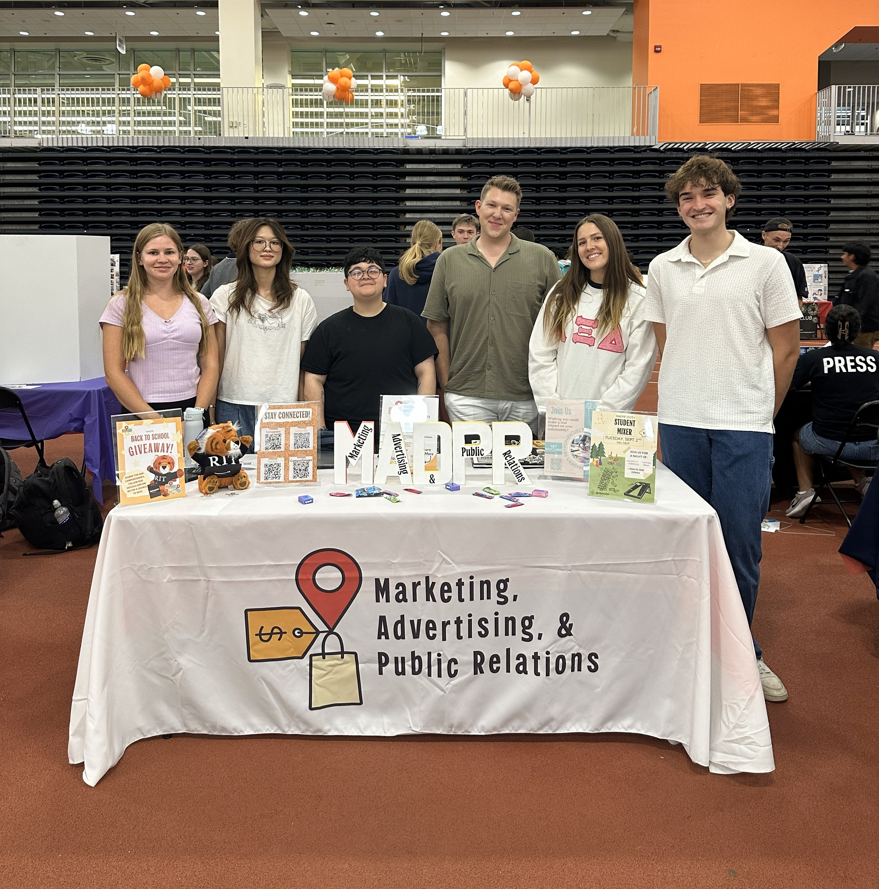 Table for the MADPR Club at RIT showing different branding materials.