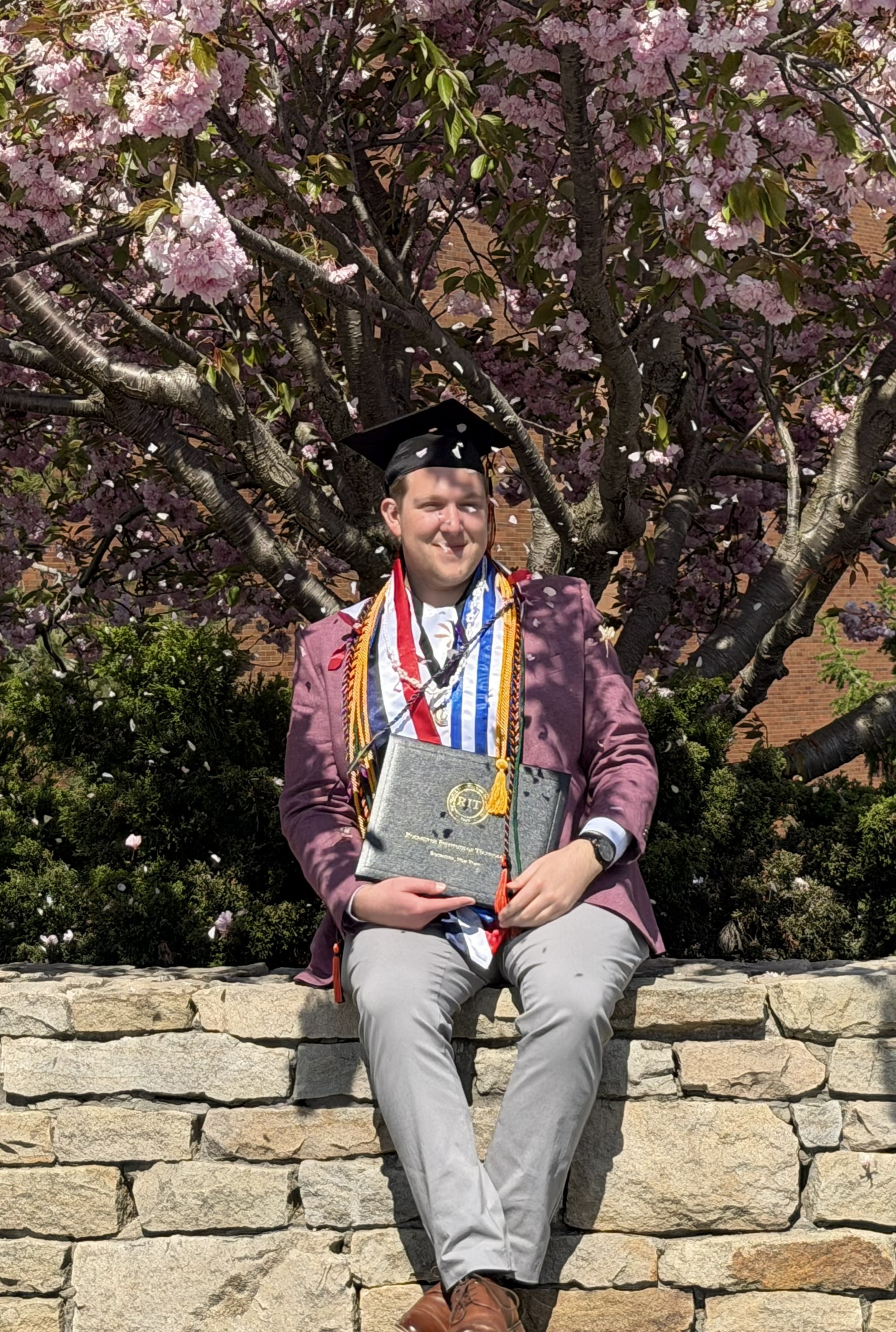 Hunter Hodge holding a bouqet of flowers in the street.
